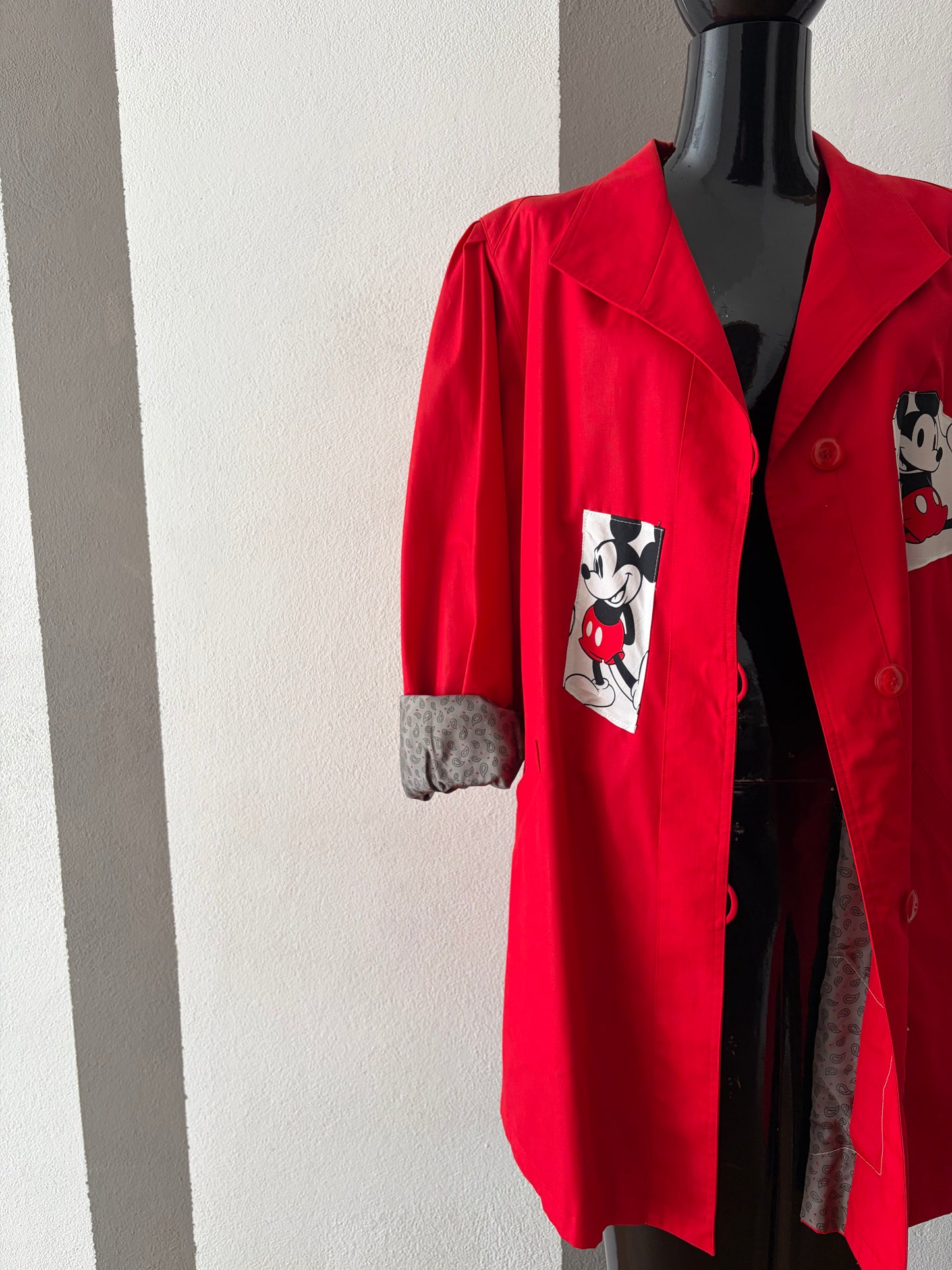 Trench rosso con profili di Mickey mouse